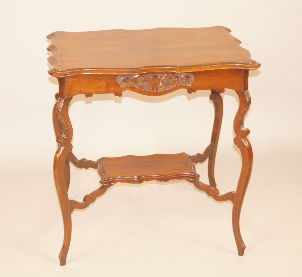 Appraisal: A Victorian walnut two tier table the rectangular top with