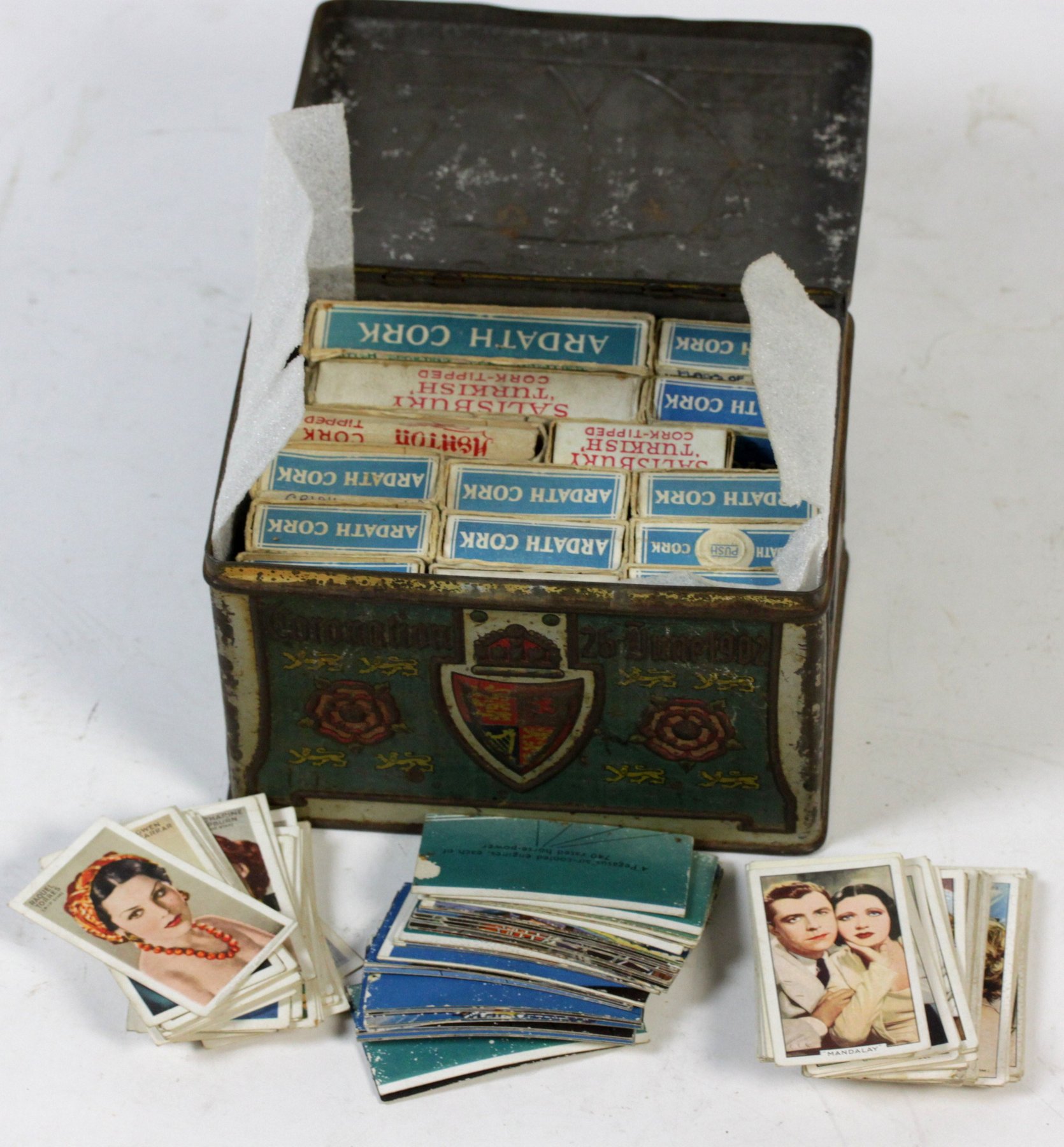 Appraisal: Sundry cigarette cards contained in a biscuit tin commemorative of