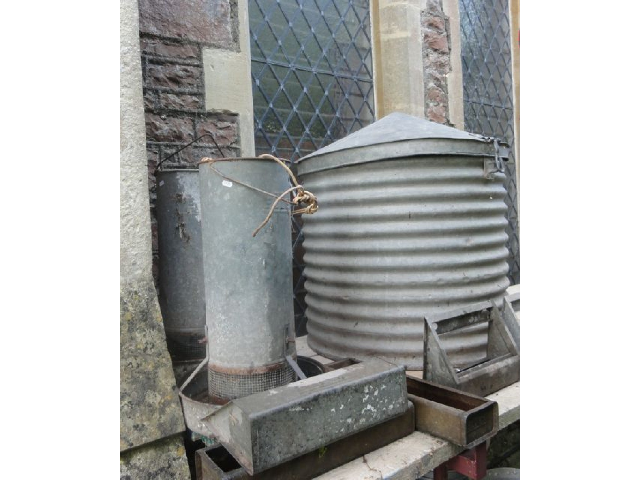 Appraisal: A vintage galvanised corrugated feed bin of cylindrical form with