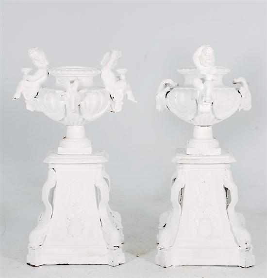 Appraisal: Pair painted cast-iron garden urns on pedestals ram's-head handles and