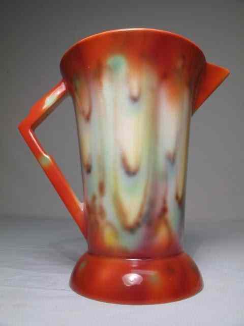 Appraisal: English Falcon Ware pitcher with mottled glaze of orange blue