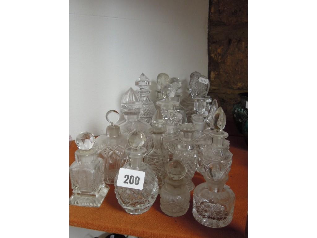 Appraisal: A collection of clear cut glass bottles and stoppers including