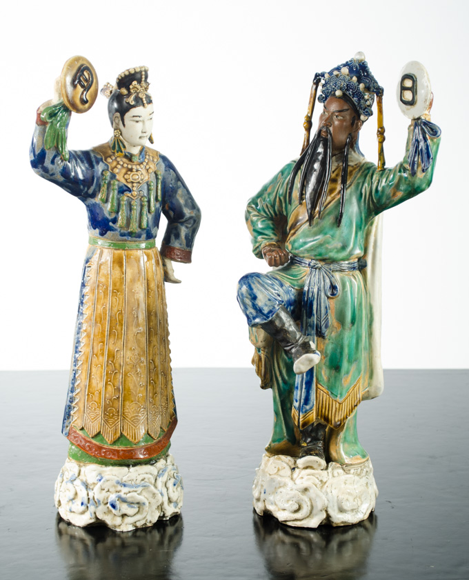 Appraisal: PAIR CHINESE POTTERY FIGURAL SCULPTURES male and female Mudmen dancers