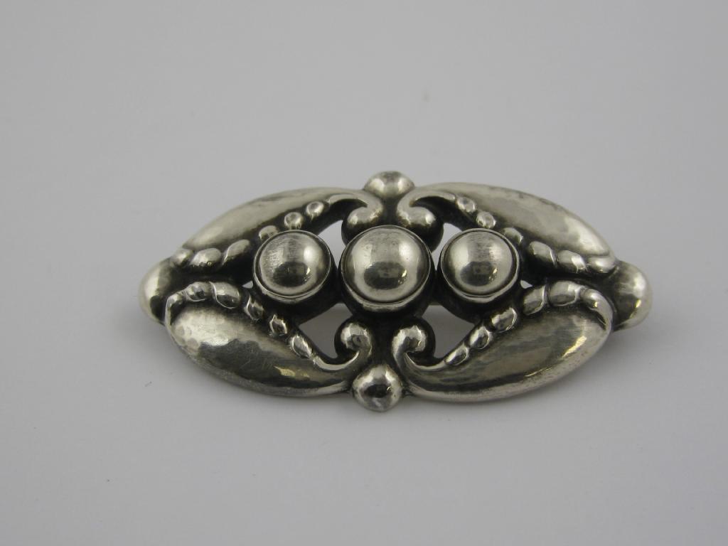 Appraisal: A George Jensen silver Brooch with pierced and embossed oval