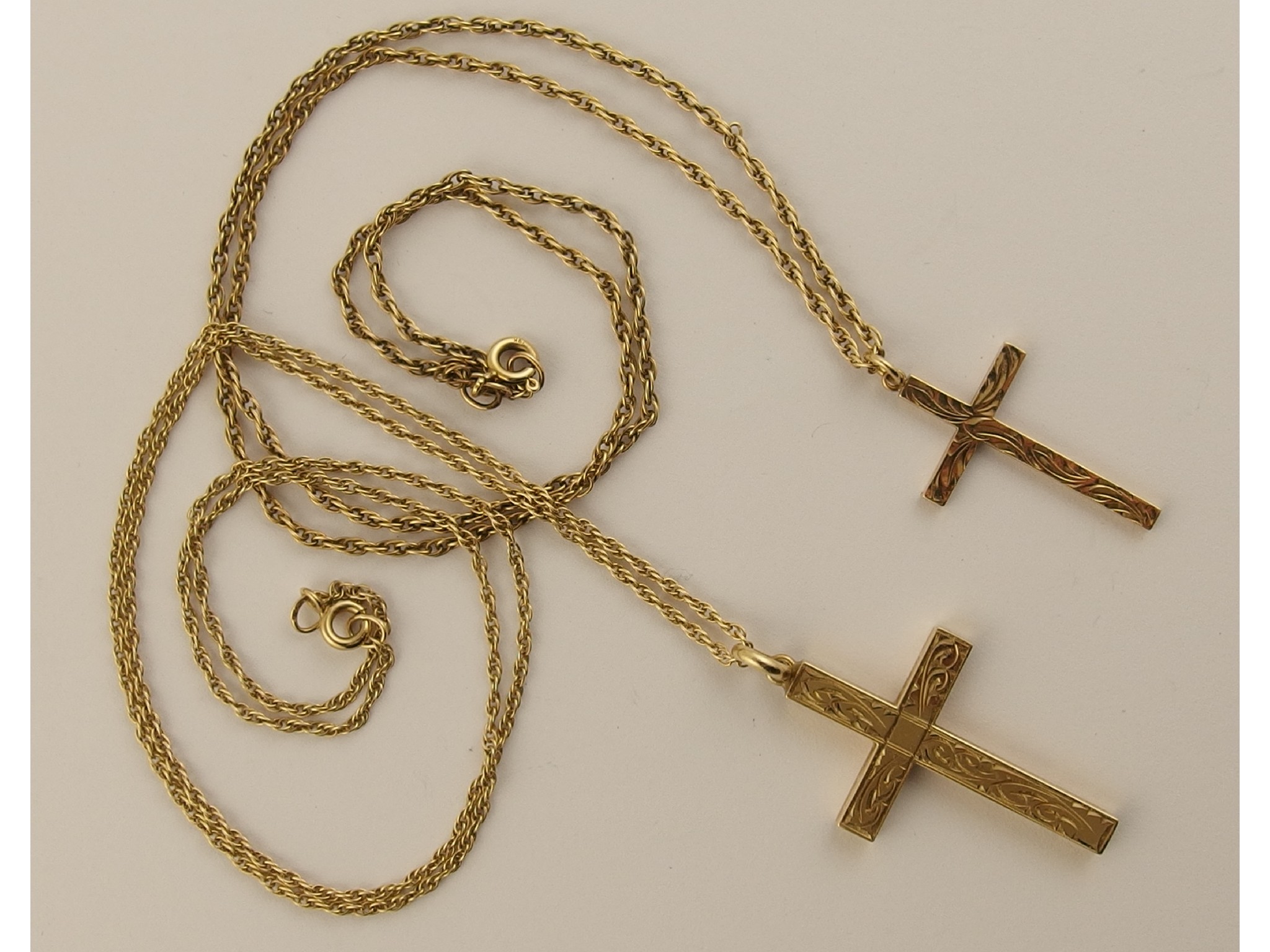 Appraisal: Two ct decoratively engraved crosses and chains weight approx gms