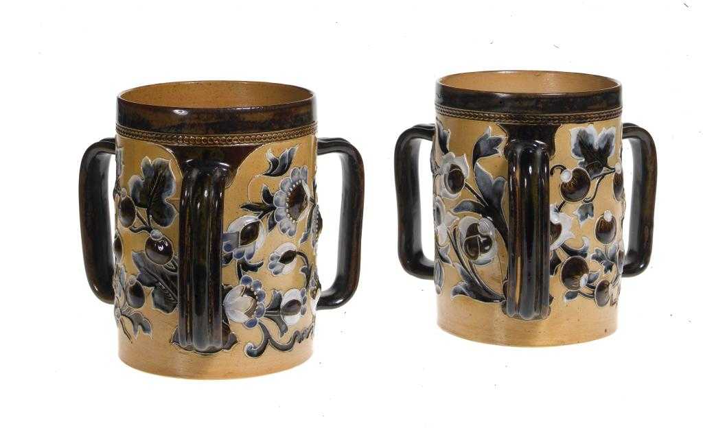 Appraisal: A PAIR OF DOULTON WARE LOVING CUPS decorated by Mark