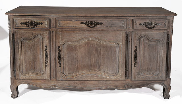 Appraisal: A FRENCH LIMED OAK DRESSER with three frieze drawers over