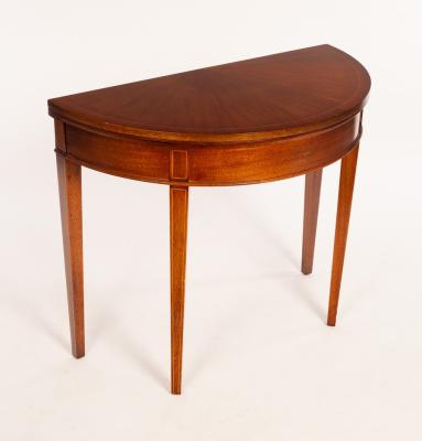 Appraisal: A mahogany D-shaped card table lined green baize on square