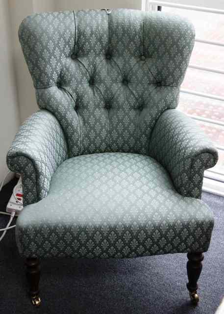 Appraisal: A Victorian style button upholstered armchair on turned legs