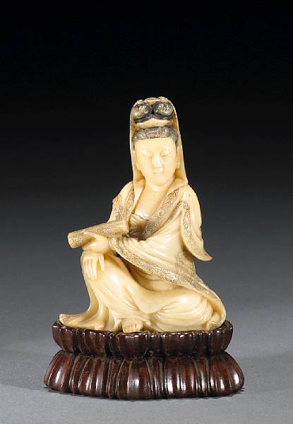 Appraisal: A small soapstone figural carving Qing Dynasty Depicting Guanyin seated