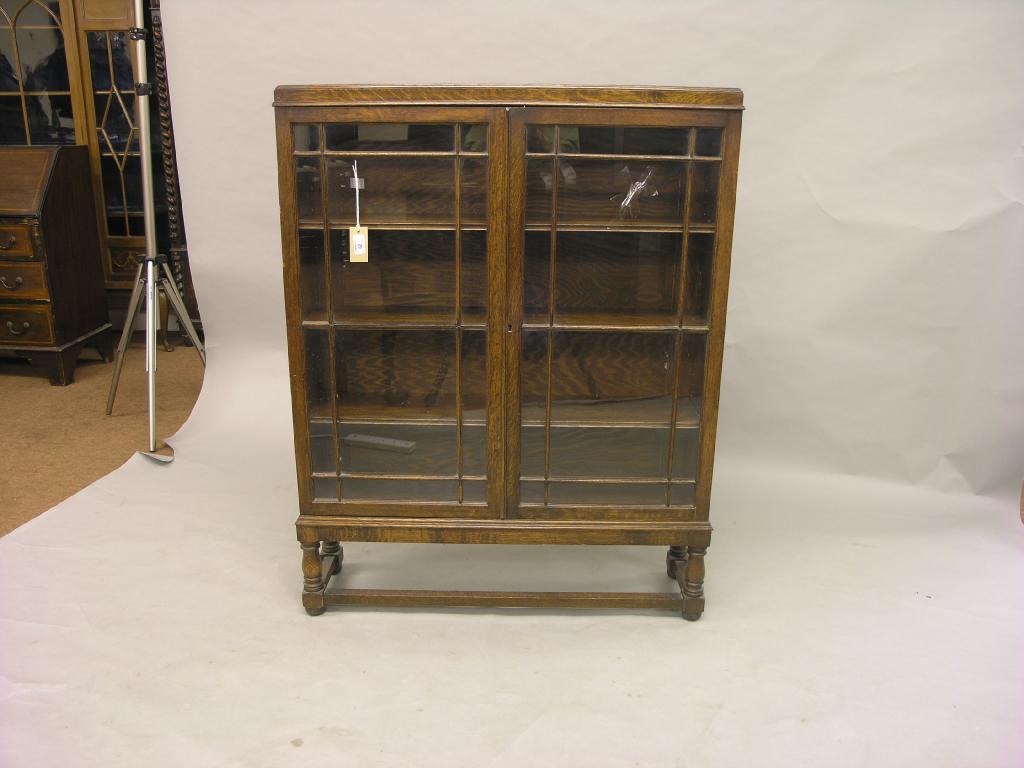 Appraisal: A 's solid oak bookcase pair of glazed doors enclosing