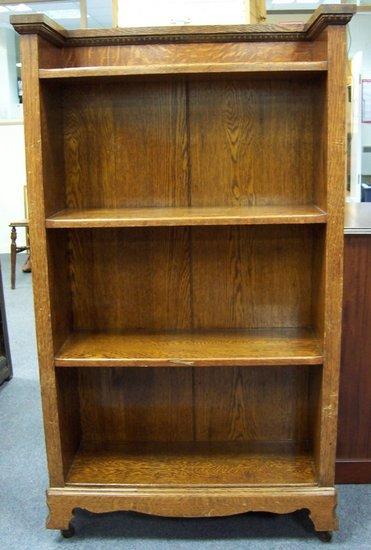 Appraisal: An oak open bookcase the top with egg and dart