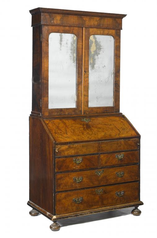 Appraisal: A GEORGE II WALNUT BUREAU-CABINET the stepped cornice above a