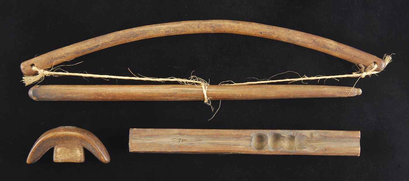 Appraisal: FOUR INUIT WOODEN FIRE-STARTING IMPLEMENTS AND AN ARROWLength of implements