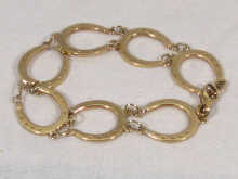 Appraisal: A carat gold bracelet in the form of seven horseshoes