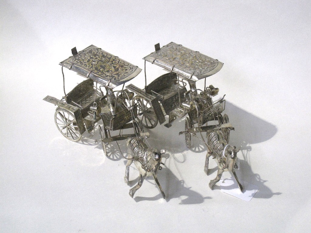 Appraisal: Pair of Eastern white metal horse and coach figures