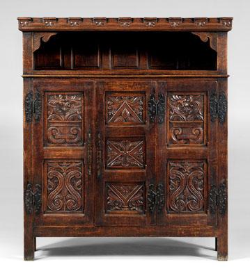 Appraisal: Renaissance style carved oak cupboard in two sections top crenellated