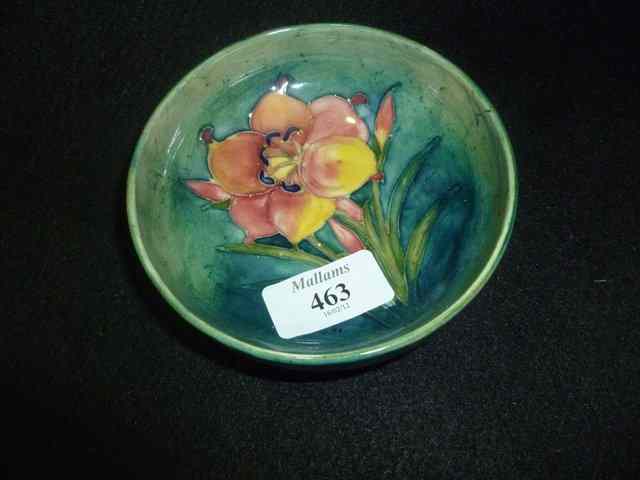 Appraisal: A MOORCROFT POTTERY SMALL CIRCULAR BOWL with freesia design on