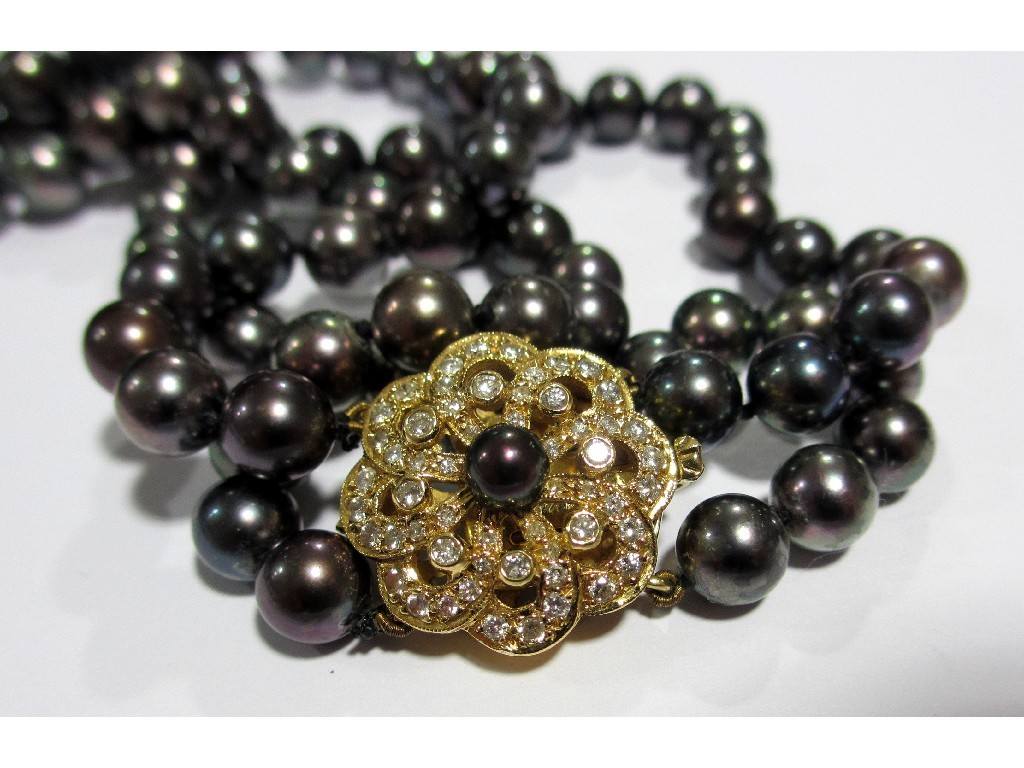 Appraisal: A cultured black pearl and diamond necklace the double strand