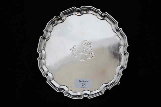 Appraisal: A SILVER WAITER with Chippendale edge and central armorial with