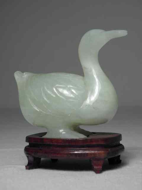 Appraisal: A Chinese carved green Nephrite jade duck Includes small wooden