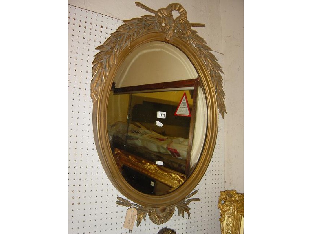 Appraisal: A th century gilt framed wall mirror with trailing leaf