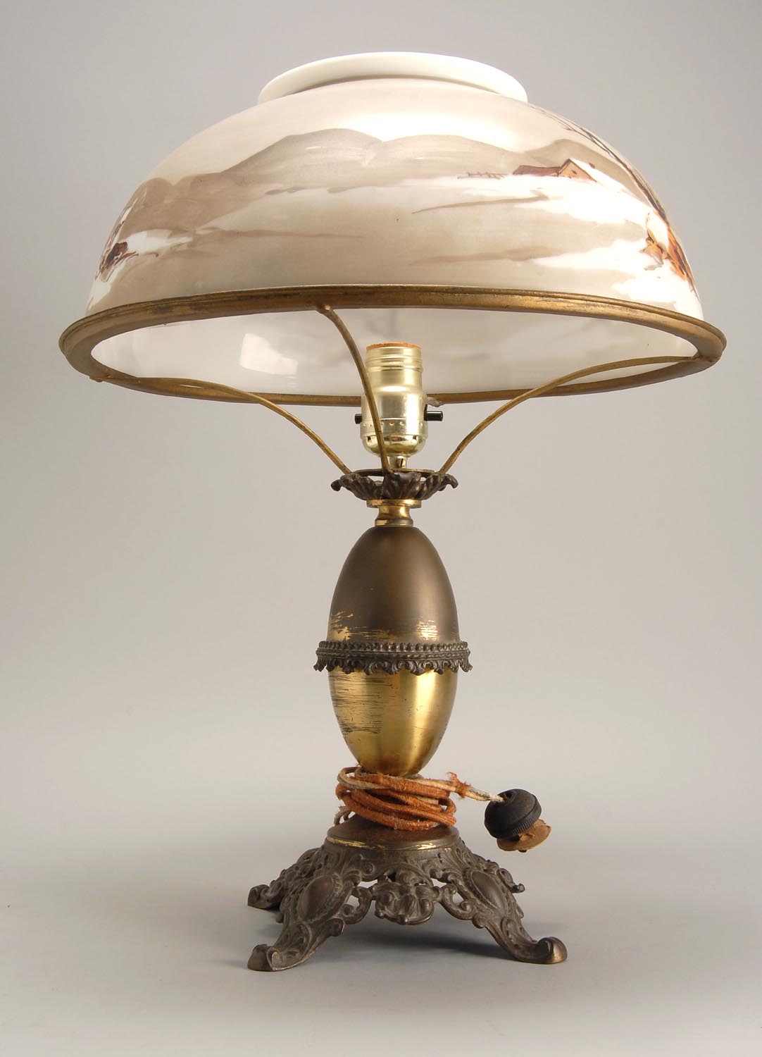 Appraisal: EARLY TH CENTURY MIXED-METAL LAMP with painted milk glass shade