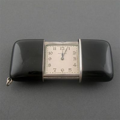 Appraisal: A black enamel and silver purse watch by Movado sliding