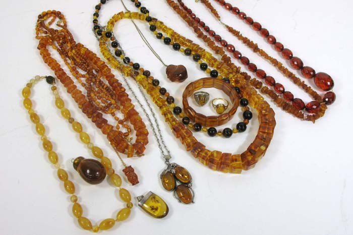 Appraisal: COLLECTION OF SIXTEEN PIECES OF AMBER COLORED JEWELRY in plastic