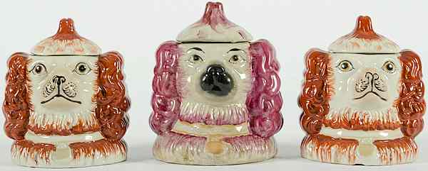 Appraisal: Staffordshire Dog Humidors English includes three Staffordshire dog lidded humidors