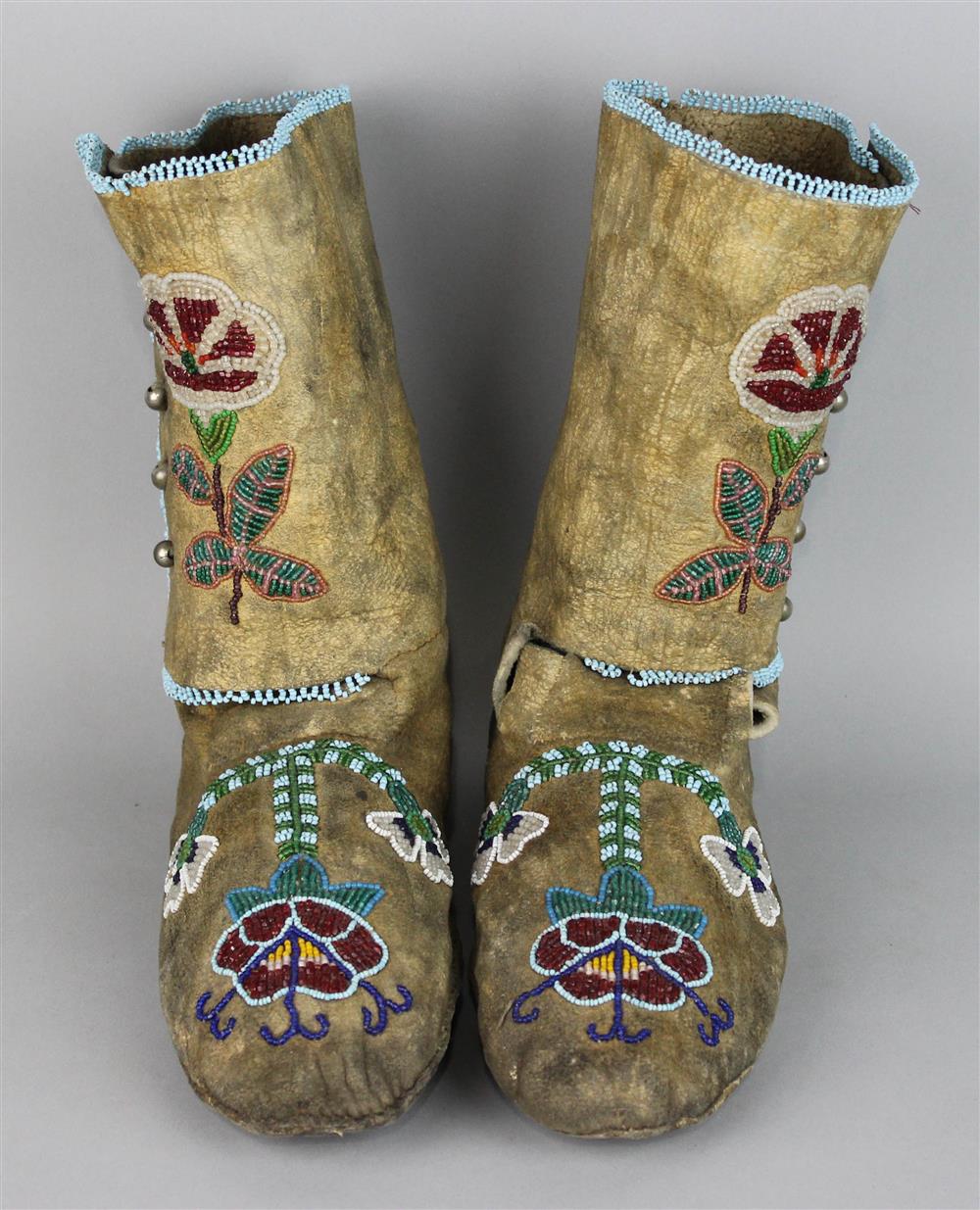 Appraisal: PAIR OF NATIVE AMERICAN HIGH-TOP BEADED HIDE MOCCASINS Provenance a