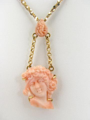 Appraisal: K yellow gold pendant with carved angel skin coral portrait