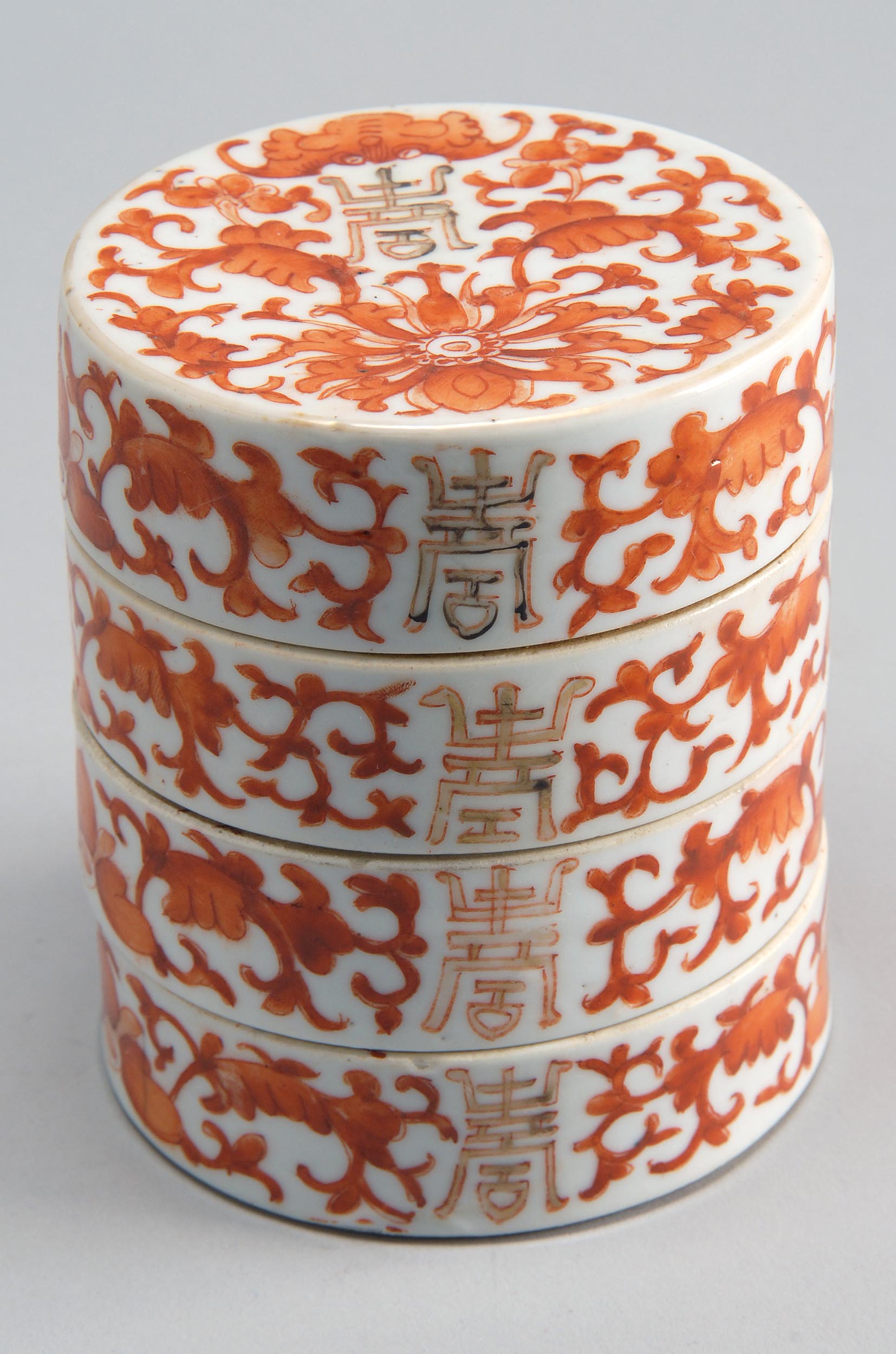 Appraisal: FOUR-SECTION PORCELAIN BOX Late th CenturyIn cylindrical form with rust-red