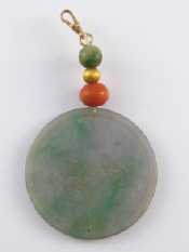 Appraisal: A jade disc pendant approx cm diameter with yellow metal