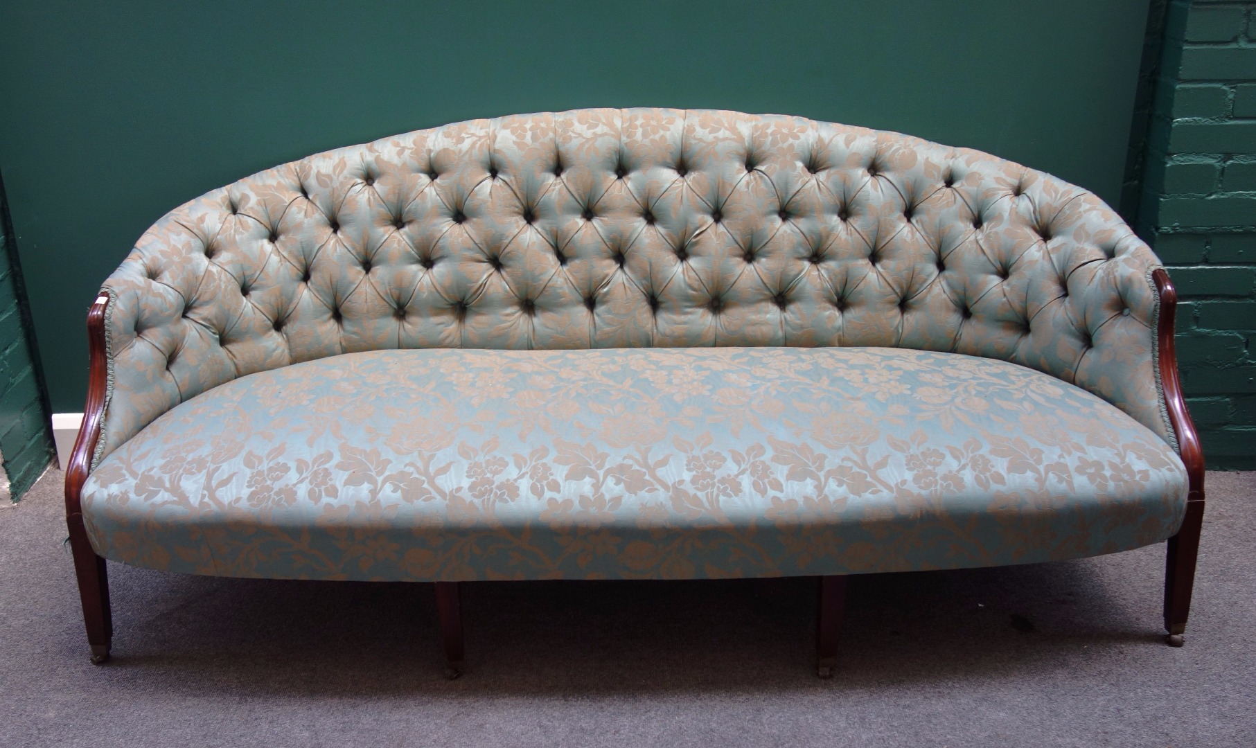 Appraisal: A pair of mid th century design button back sofas