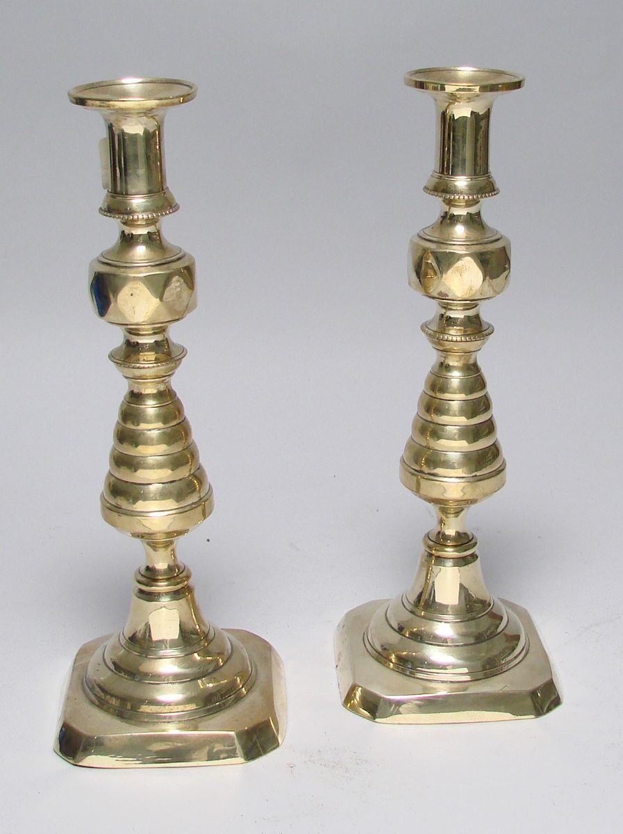 Appraisal: PAIR OF ANTIQUE BRASS PUSH-UP CANDLESTICKS Mid- th CenturyIn Beehive