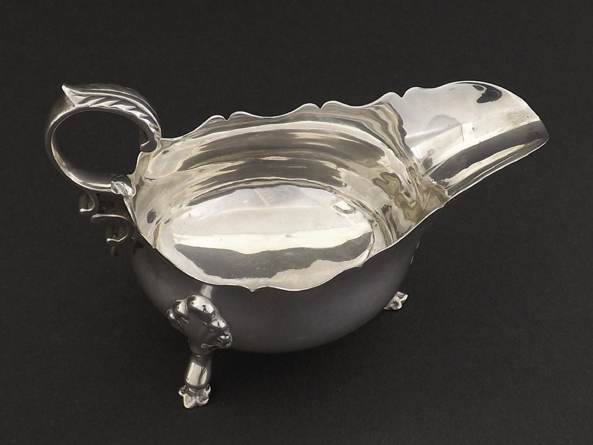 Appraisal: Edwardian silver sauceboat with C-scroll handle and shell backed hoof