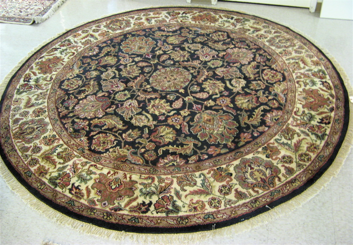 Appraisal: A ROUND ORIENTAL CARPET Indo-Persian floral design on black field