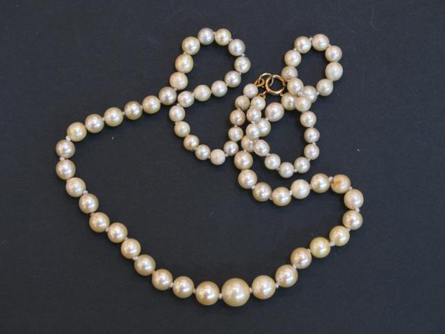 Appraisal: A SINGLE ROW GRADUATED PEARL NECKLACE with plain gold finding