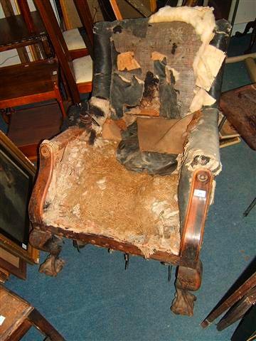 Appraisal: An early th Century rosewood library armchair standing on anthropomorphic