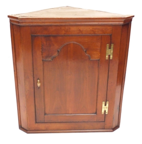 Appraisal: A thC fruitwood corner cupboard with an arched panelled door