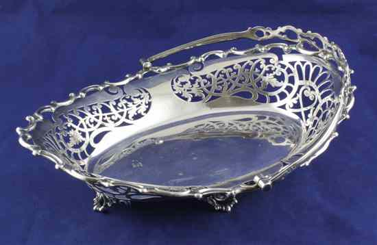 Appraisal: An Edwardian pierced silver oval cake basket with scroll border