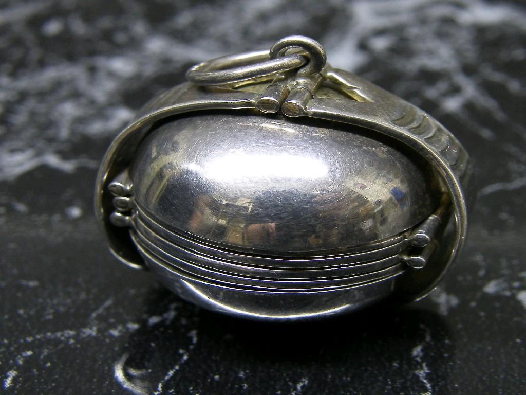 Appraisal: Unusual silver pendant locket opening to reveal circular mirrored compartments