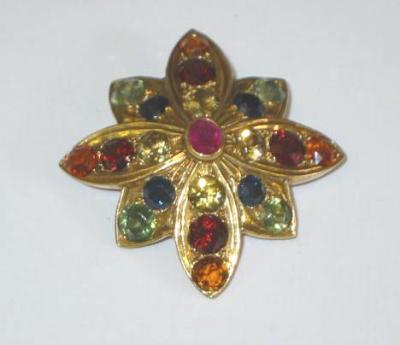 Appraisal: A GOLD MULTI GEM BROOCH modelled as a flower head