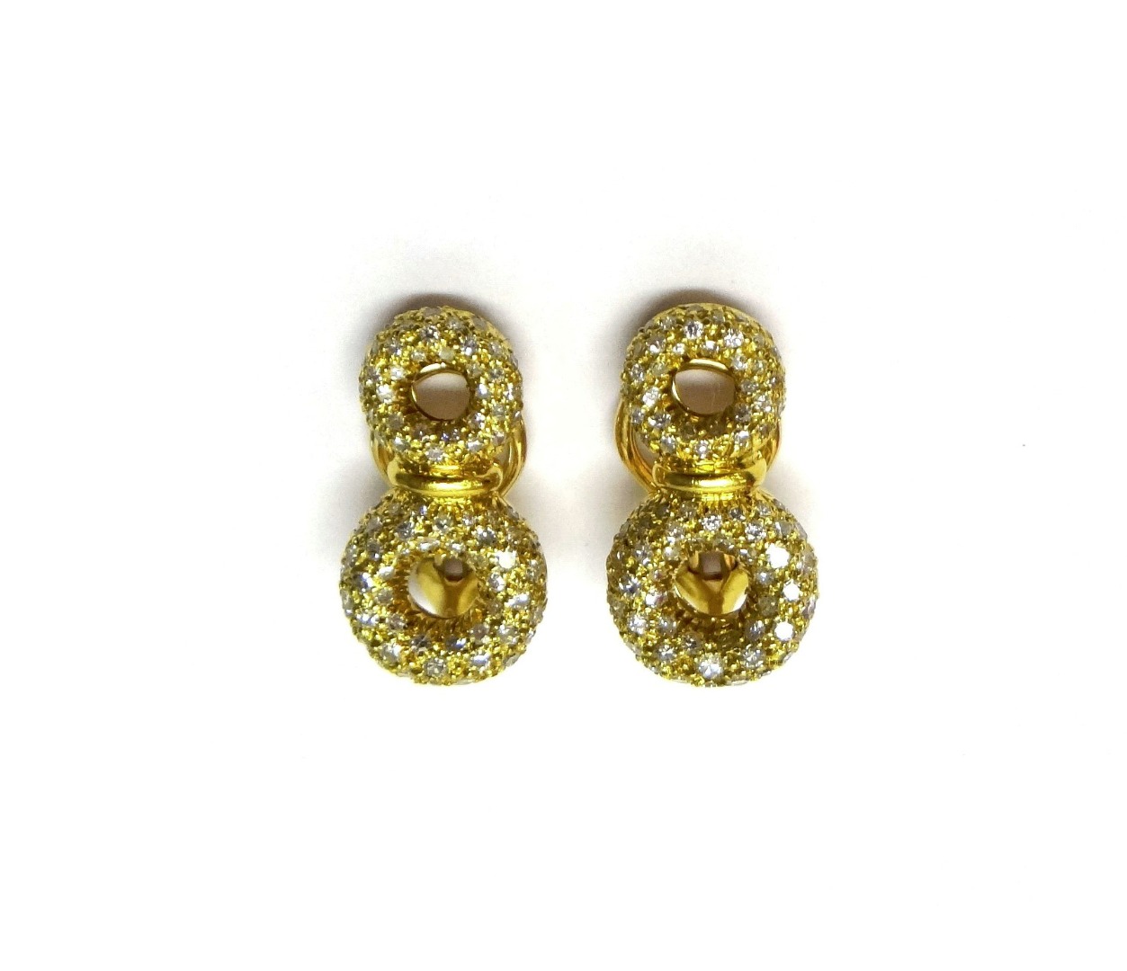 Appraisal: A pair of gold and diamond set earclips by Bijan