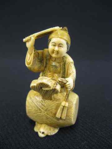 Appraisal: Carved Ivory Netsuke of a Man holding a fan while