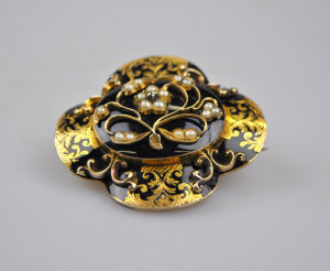 Appraisal: Large Victorian quatrefoil mourning brooch with scroll work and black