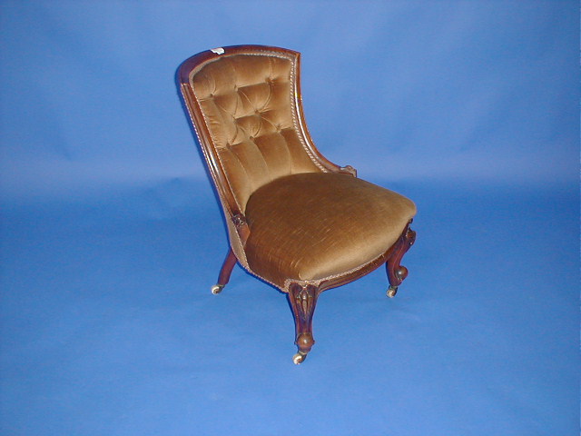 Appraisal: A Victorian walnut nursing chair with shaped back upholstered in