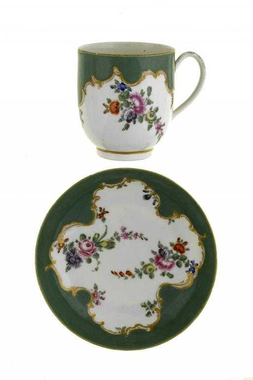 Appraisal: A WORCESTER GREEN GROUND COFFEE CUP AND SAUCER enamelled with