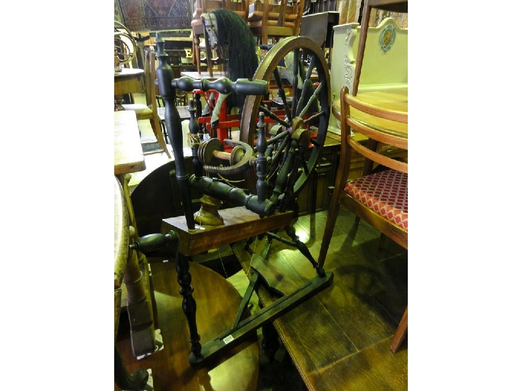 Appraisal: A folk art style treadle spinning wheel and attachments with